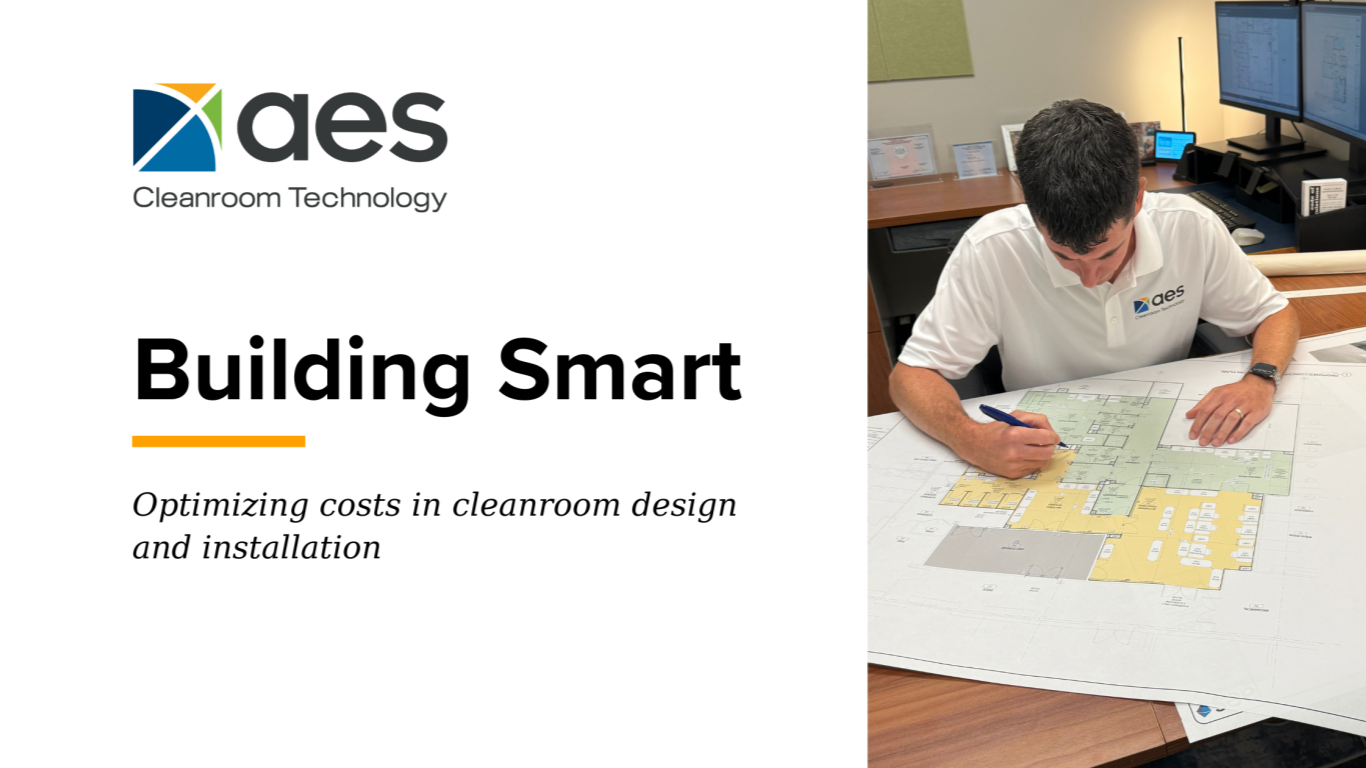 image of an AES cleanroom technology team member at their desk working on a cleanroom design blueprint for a pharmaceutical manufacturing client